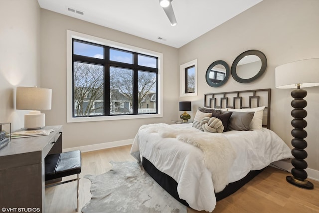 bedroom with ceiling fan and light hardwood / wood-style floors