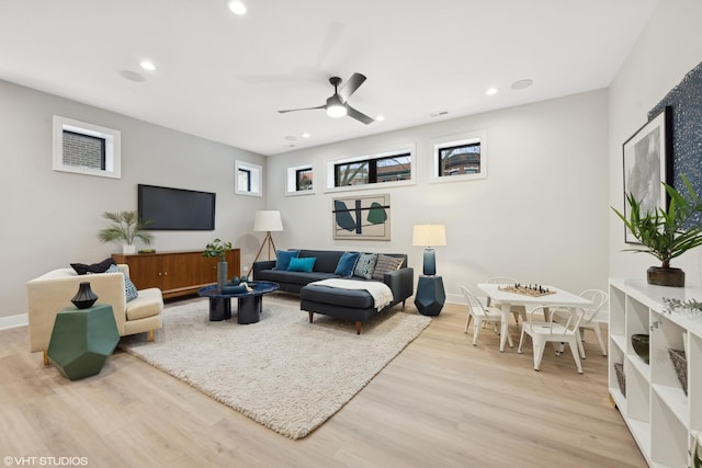 living room featuring ceiling fan and light wood-type flooring