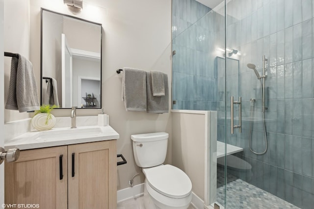 bathroom featuring walk in shower, vanity, and toilet