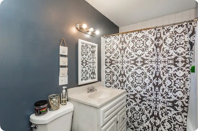 bathroom featuring vanity, curtained shower, and toilet