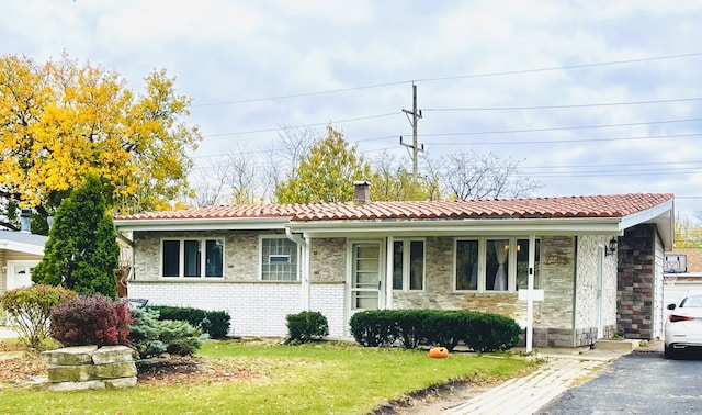 ranch-style house with a front yard and covered porch