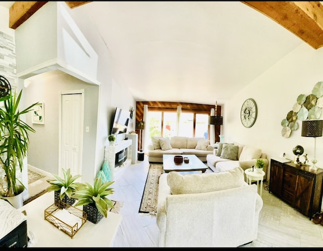 living room with lofted ceiling with beams