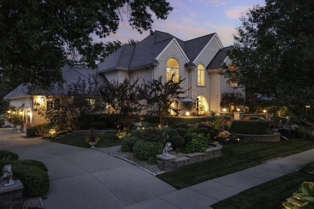 french provincial home featuring a lawn