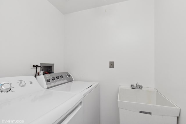 laundry area with washer and clothes dryer and sink