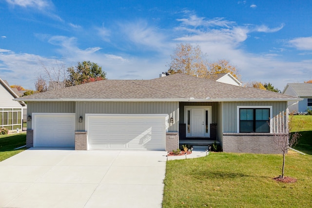 single story home featuring a garage and a front lawn