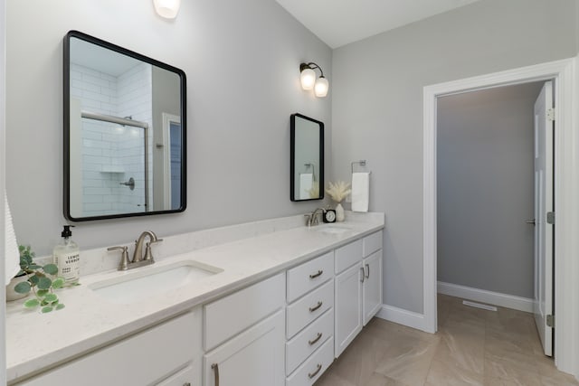 bathroom with vanity and a shower with shower door