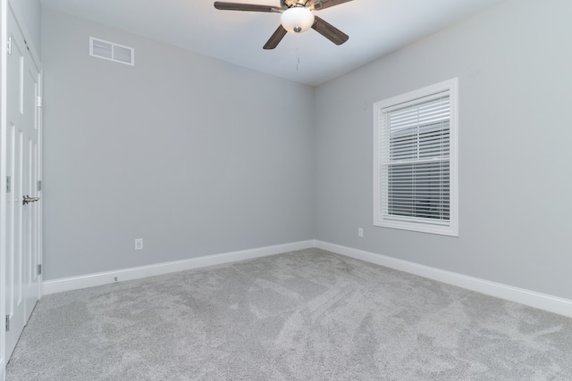 carpeted spare room with ceiling fan