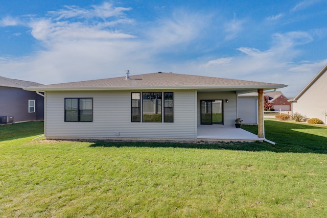 back of house featuring a lawn, central AC, and a patio area