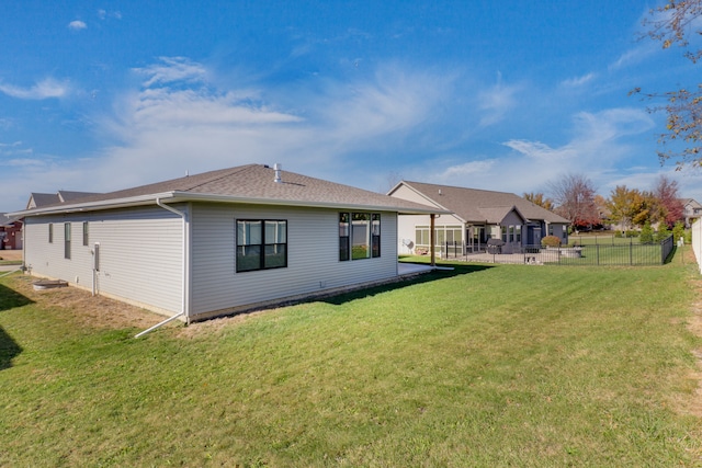 back of house with a lawn