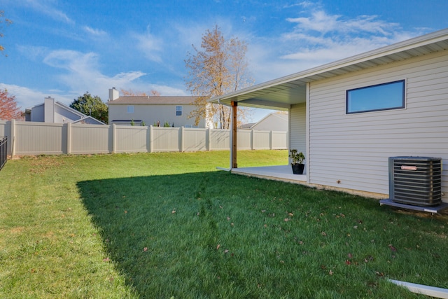 view of yard with central AC and a patio