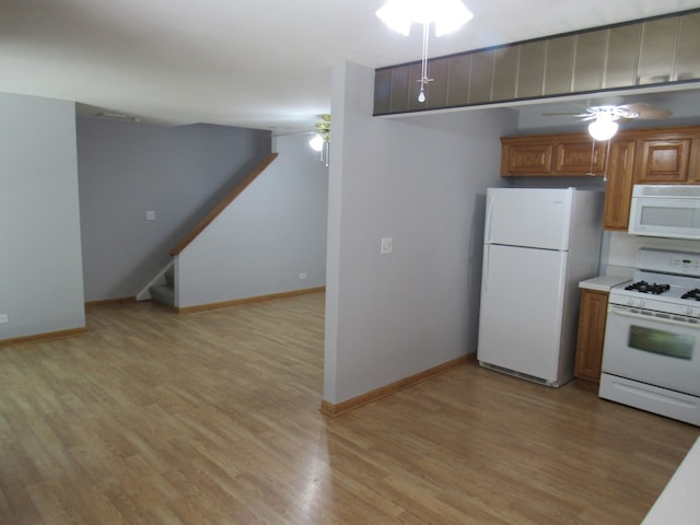 kitchen featuring white appliances, ceiling fan, and light hardwood / wood-style flooring