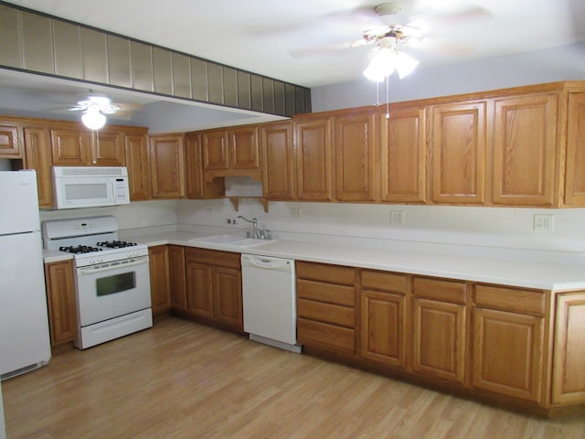 kitchen featuring light hardwood / wood-style flooring, sink, white appliances, and ceiling fan