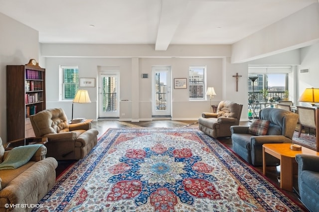 living room with beamed ceiling and hardwood / wood-style flooring