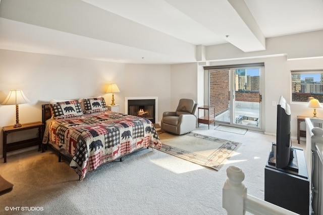 carpeted bedroom featuring beamed ceiling and access to outside