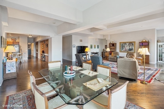 dining space with beam ceiling and dark wood-type flooring