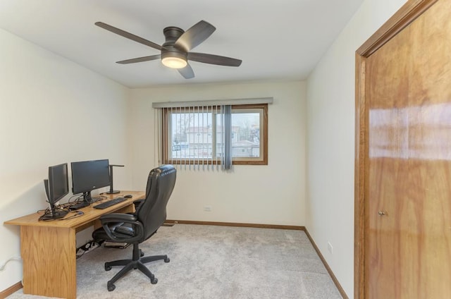 carpeted office featuring ceiling fan