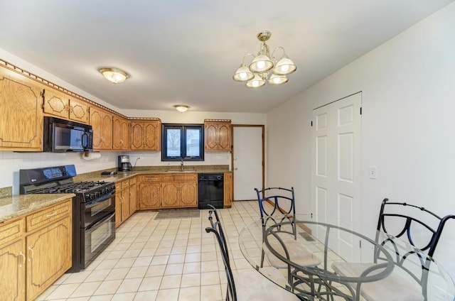 kitchen with pendant lighting, light tile patterned floors, sink, an inviting chandelier, and black appliances