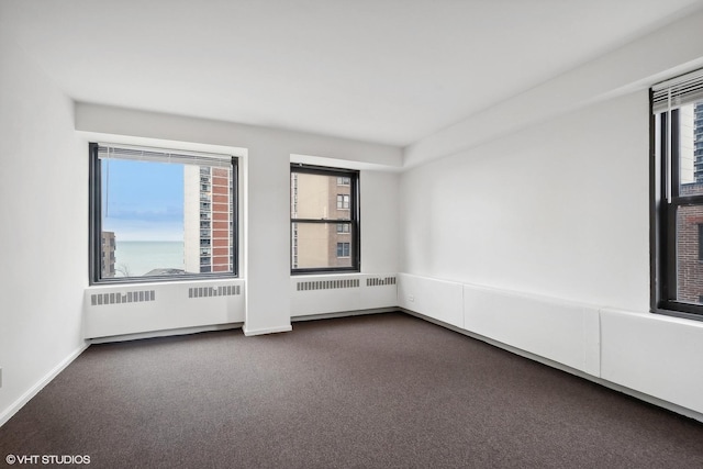 empty room with carpet and radiator