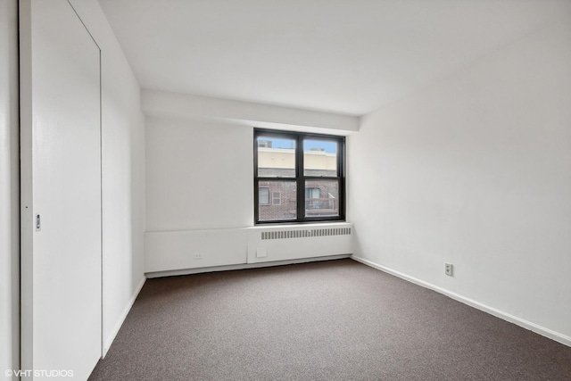 empty room featuring carpet and radiator