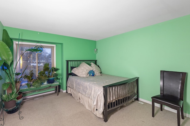 bedroom featuring light colored carpet