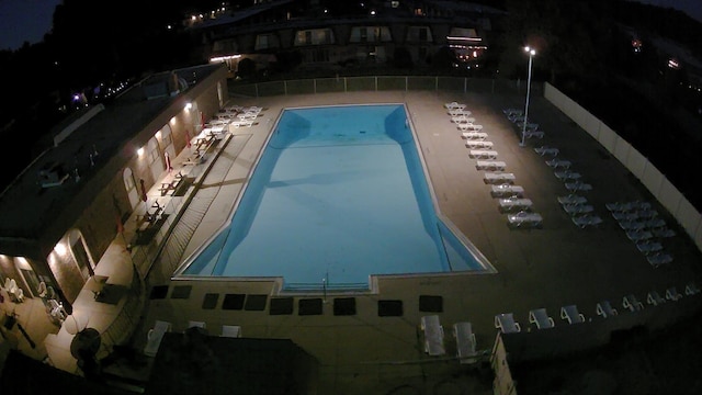 pool at twilight with a patio