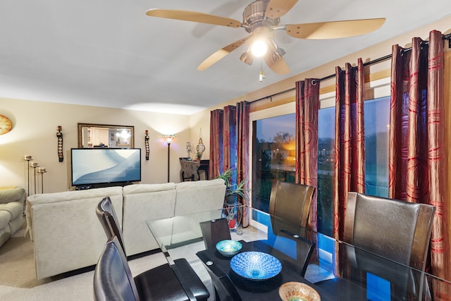 carpeted dining space featuring ceiling fan