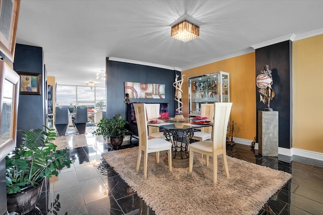 dining area with crown molding and a notable chandelier