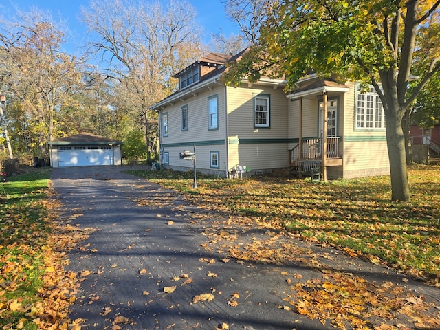 view of side of property with an outdoor structure and a garage