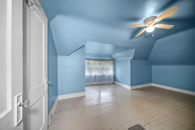 bonus room with light hardwood / wood-style flooring, ceiling fan, and lofted ceiling