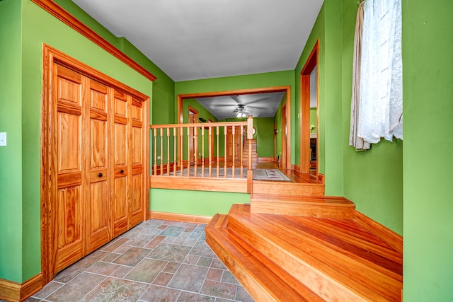 interior space with ceiling fan