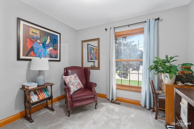 living area featuring light carpet