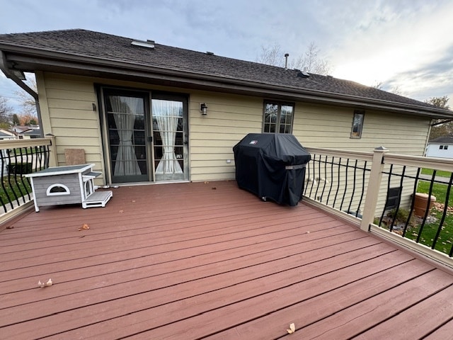 wooden deck featuring a grill