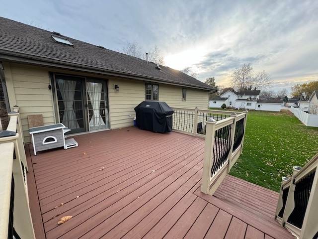 wooden terrace with a yard and area for grilling