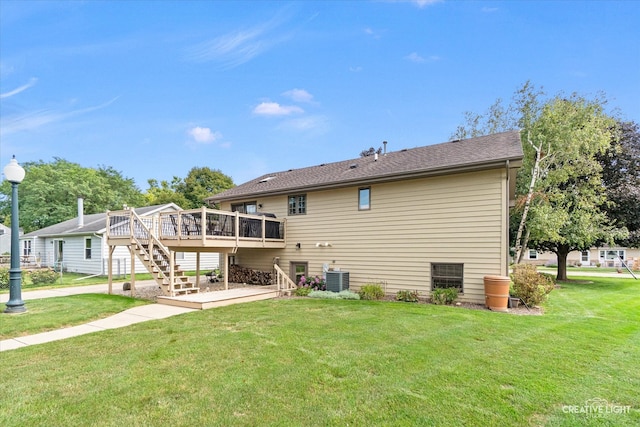 back of property featuring cooling unit, a yard, and a wooden deck