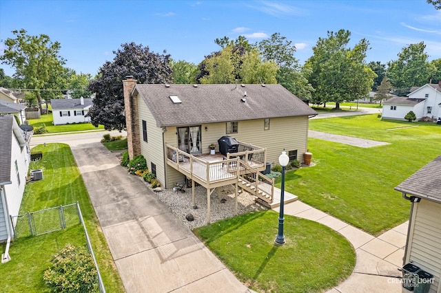 back of house with a lawn, central AC, and a deck