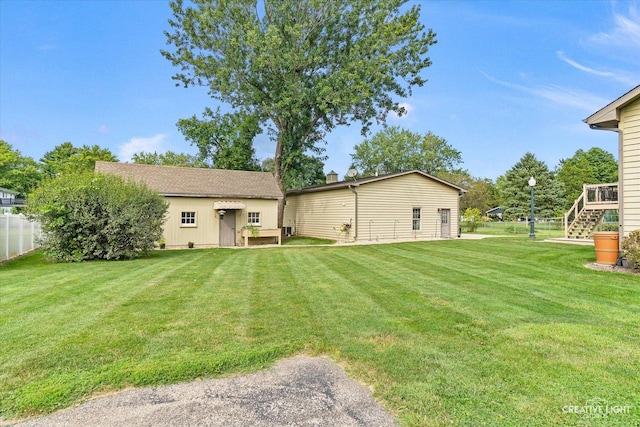 rear view of house featuring a lawn