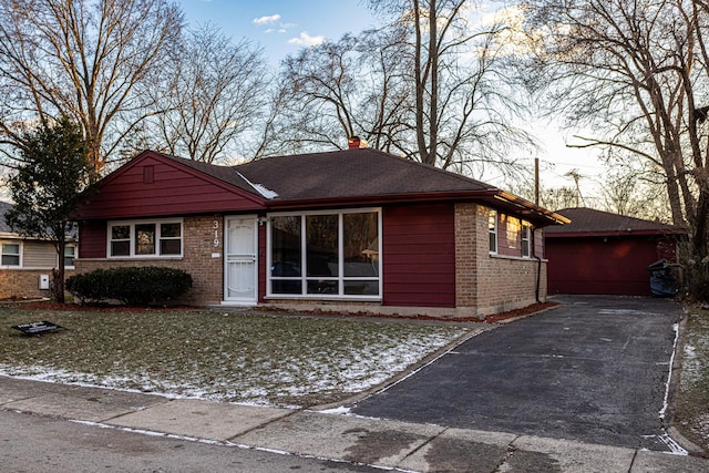 single story home with a garage and a front lawn