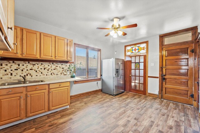 2425 W 46th Pl, Chicago, IL 60632 - kitchen with stainless steel refrigerator with ice dispenser, a sink, a ceiling fan, baseboards, and tasteful backsplash
