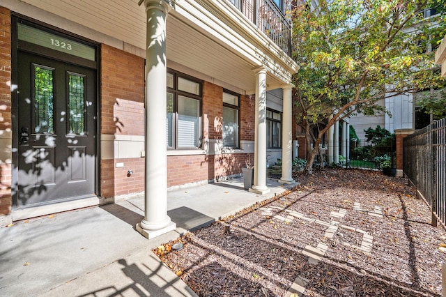 view of exterior entry with covered porch