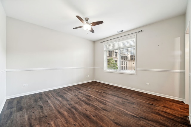 empty room featuring dark hardwood / wood-style floors and ceiling fan