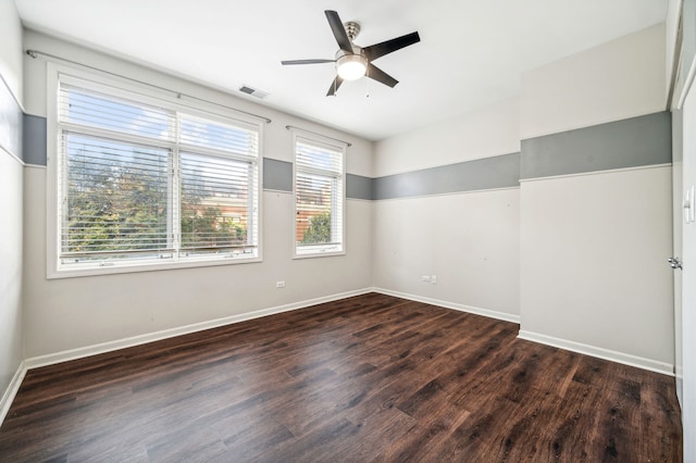 empty room featuring dark wood-type flooring and ceiling fan