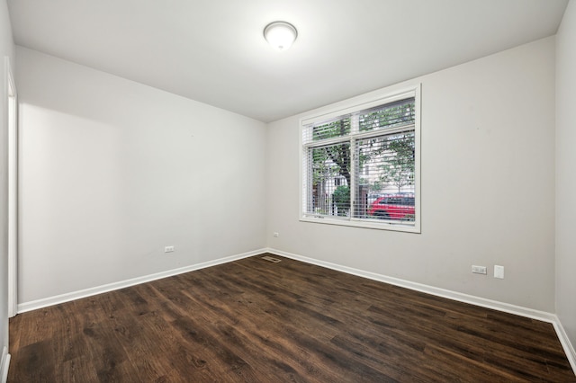 spare room featuring dark hardwood / wood-style flooring