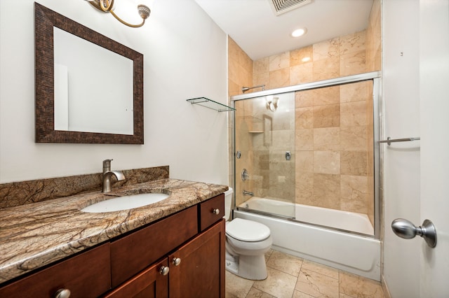 full bathroom featuring toilet, combined bath / shower with glass door, and vanity