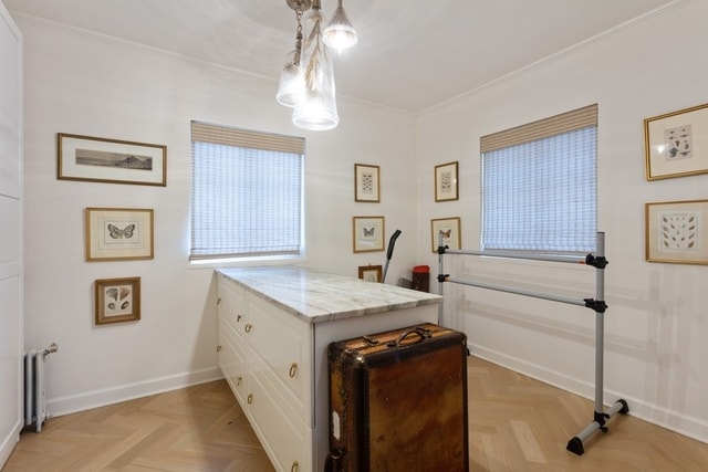 interior space with radiator, crown molding, and parquet floors