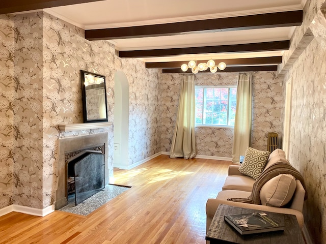 unfurnished room with beamed ceiling, hardwood / wood-style floors, and crown molding