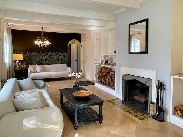 living room featuring crown molding, light parquet flooring, a healthy amount of sunlight, and an inviting chandelier