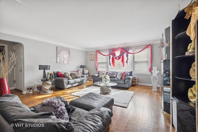 living room with wood-type flooring and crown molding