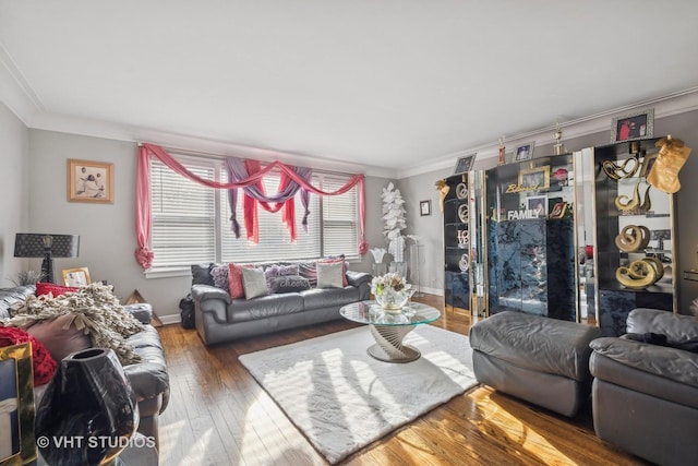 living room featuring hardwood / wood-style flooring and crown molding