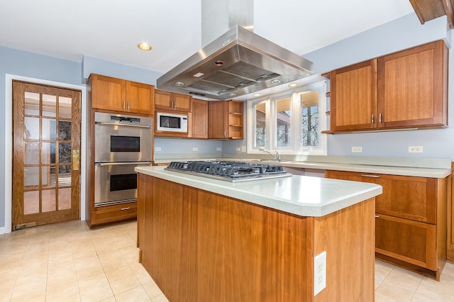 kitchen with island exhaust hood, appliances with stainless steel finishes, sink, light tile patterned floors, and a center island