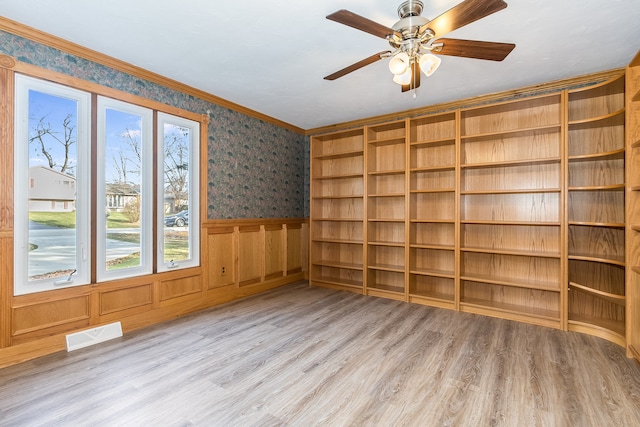 spare room featuring crown molding, ceiling fan, and light hardwood / wood-style floors